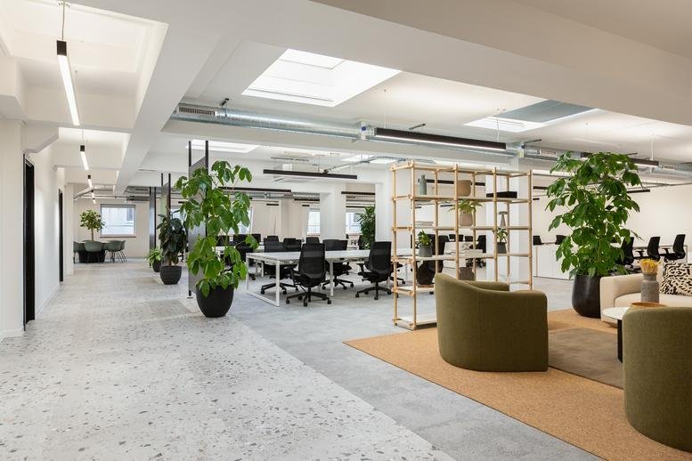 Spacious common area at Chadwick Court with natural light from skylights and abundant greenery.