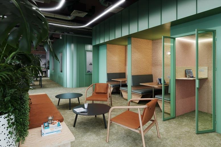 Spacious communal lounge at The Social Hub, 15 Candleriggs Square, featuring modular seating and wood-paneled booths.