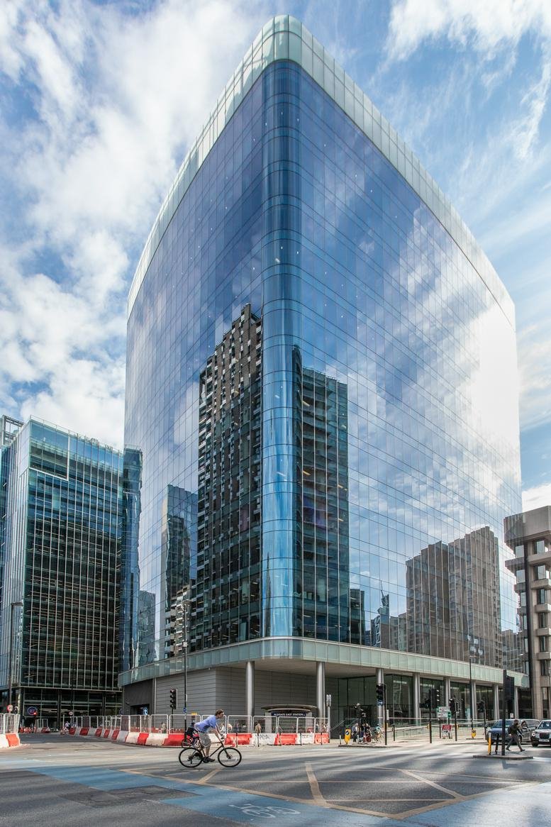 Exterior view of the glass-facade modern office building at 2 Leman Street.