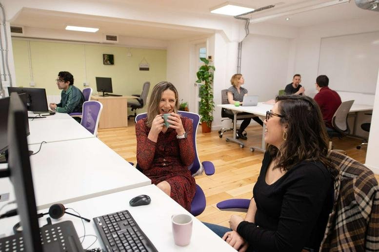 Spacious open-plan workspace at 22 Montrose Street, Glasgow, G1 1RE with purple chairs and natural light.