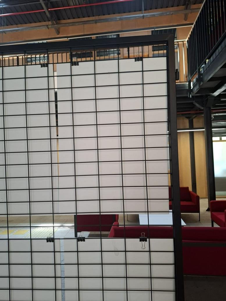 Industrial style interior at 25, Calea Dorobanților, etaj 1, apartament 30, Cluj Napoca with red sofas and mesh partitions.