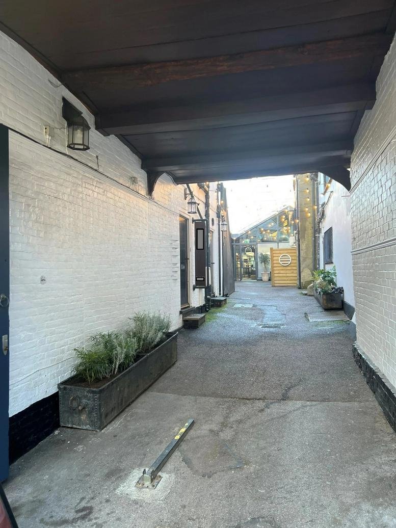 Exterior entrance and alleyway leading to 26 C George Street, First Floor.