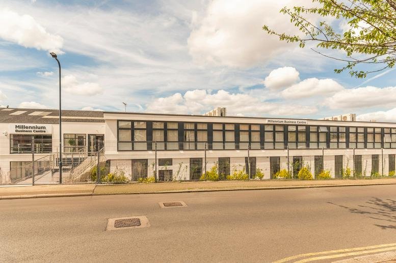 Exterior view of the Millennium Business Centre with its modern white facade and large windows.