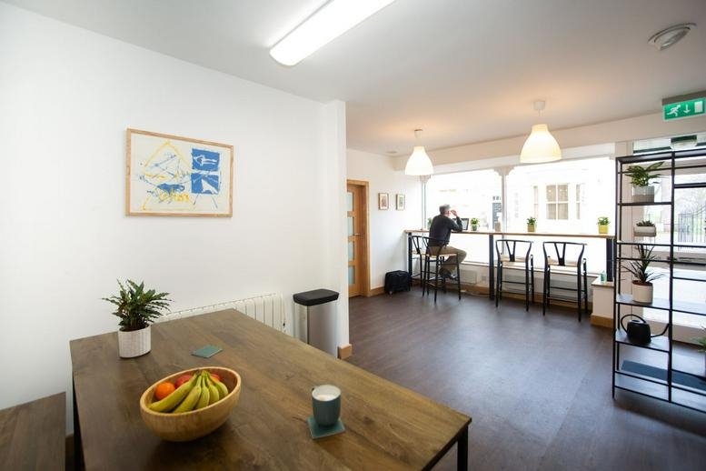 Spacious breakroom at 4 Hencotes, Hexham, Northumberland featuring a wooden table, fruit bowl, and lounge area.