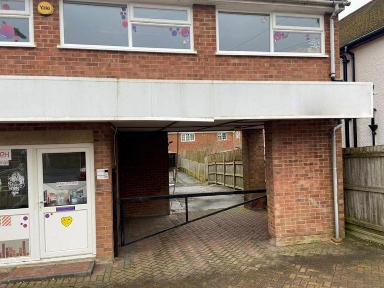 Exterior brick facade of 51 Clarence Road featuring a covered entrance and large windows.