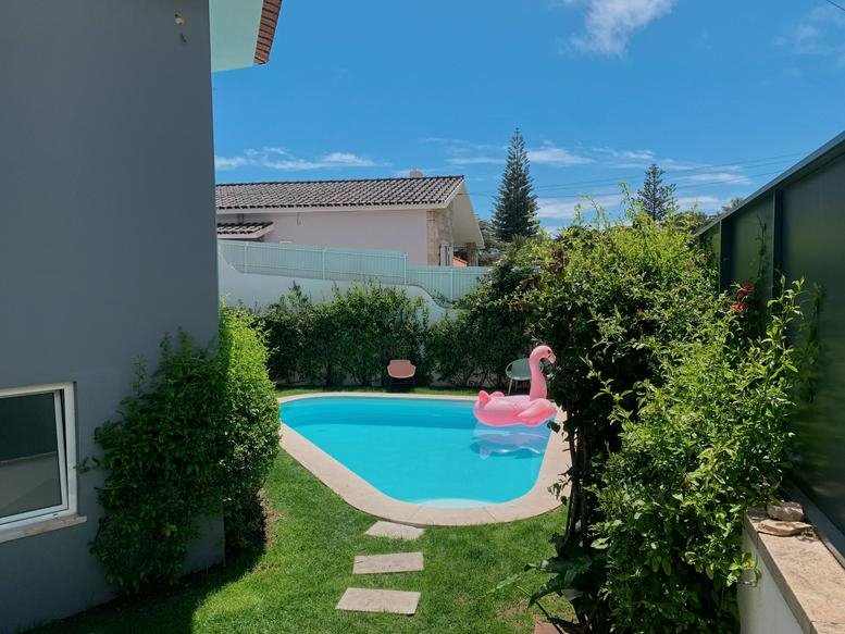 Landscaped outdoor area at Avenue Costa Pinto 560 featuring a small swimming pool and garden greenery.