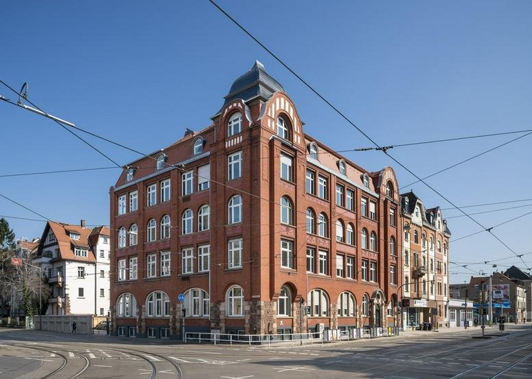 Exterior view of the ornate red brick building at Bergheimer Straße 104.