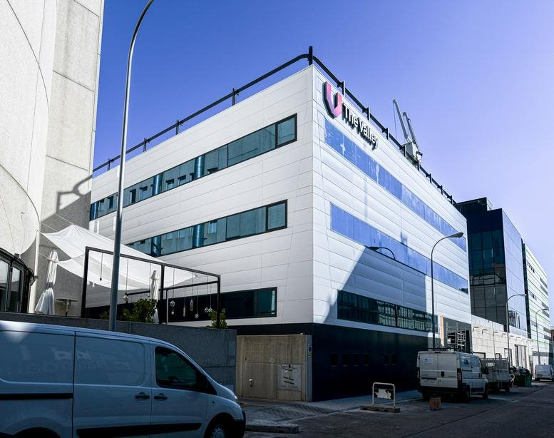 Exterior view of the modern white office building at Calle Torregalindo, 1, Madrid.