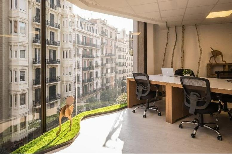 Spacious office workspace with floor-to-ceiling windows at Carrer de Muntaner 239, Sarrià-San Gervasi, Barcelona.