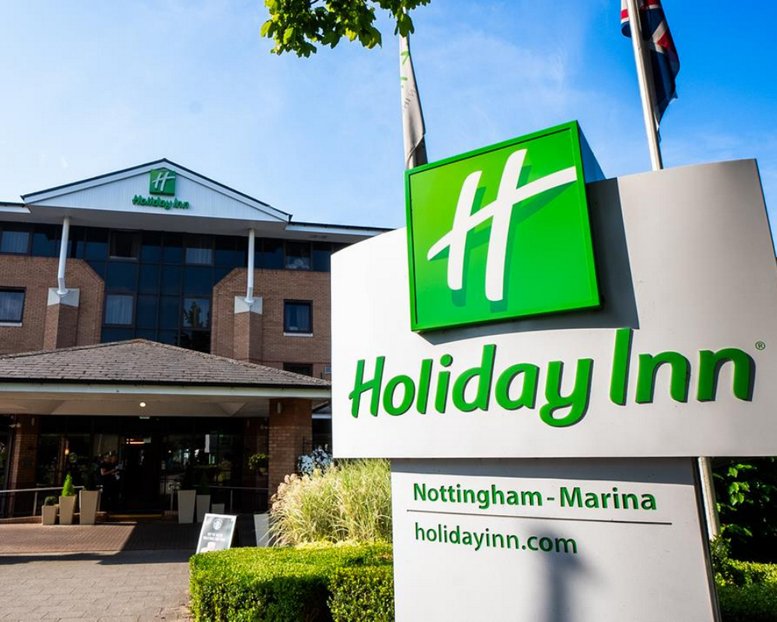 Exterior of the Holiday Inn Nottingham - Marina building featuring a large green sign and brick facade.