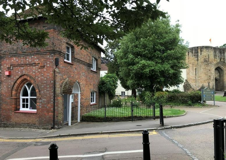 Exterior view of the historic red brick Castle Lodge, Castle Street, Tonbridge with arched windows.