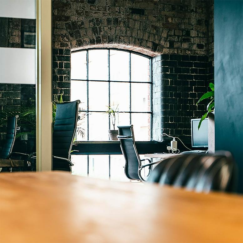 Characterful industrial office at Cotton End, Northampton with exposed brickwork and large arched windows.