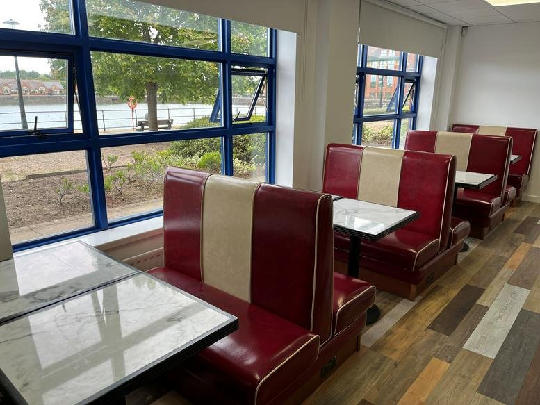 Diner-style red and cream booths in a bright break area at Edward VII Quay, Navigation Way, Unit 1 and 2, Preston.
