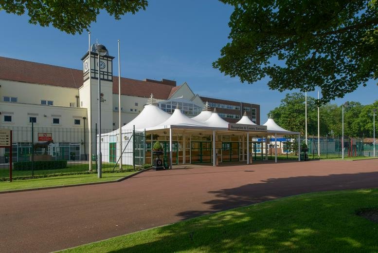 Exterior of the Haydock Park Racecourse Executive Box featuring white peaked event tents.