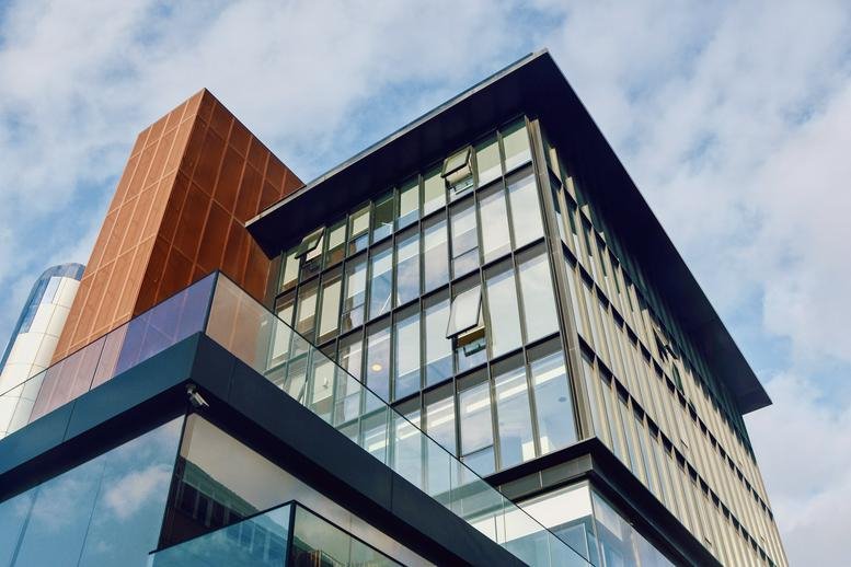 Exterior view of the modern glass-facade Nisbetiye building at Nisbetiye Cd No: 24.