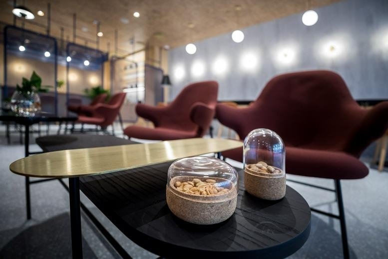 Spacious lounge at Paulay Ede utca 3 with stylish armchairs and warm, ambient lighting.