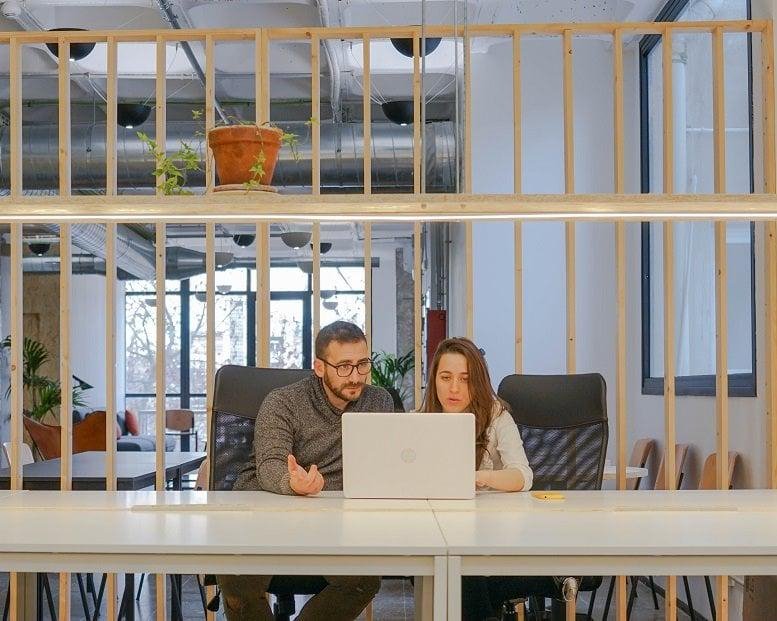 Spacious communal coworking area at Rambla Marina 456, Hospitalet, Barcelona with wooden dividers.