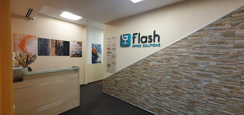 Bright reception area of Rosetti Tower featuring stone-textured wall and branded signage.