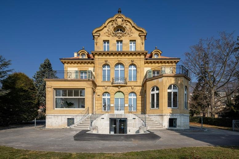 Exterior view of the historic villa at Route des falaises 140, Neuchatel featuring ornate architectural details.