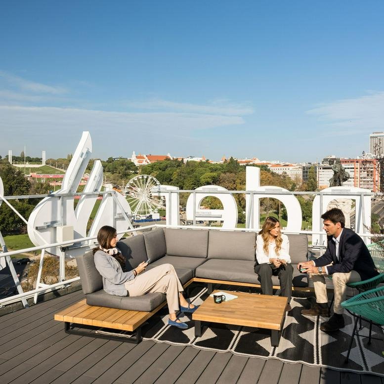 Outdoor rooftop terrace at Monday Marquês de Pombal featuring modern sofas and city views.