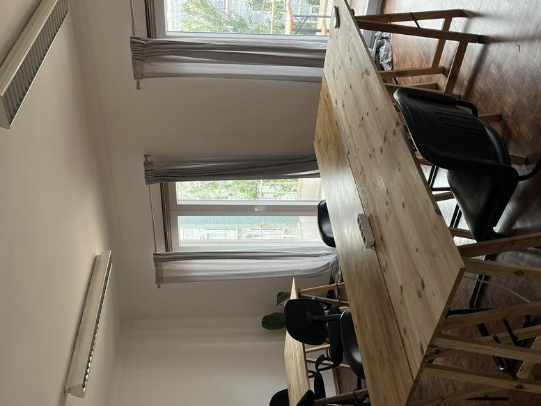 Coworking space at 54 Avenida Almirante Reis, Anjos with wooden tables and black chairs.