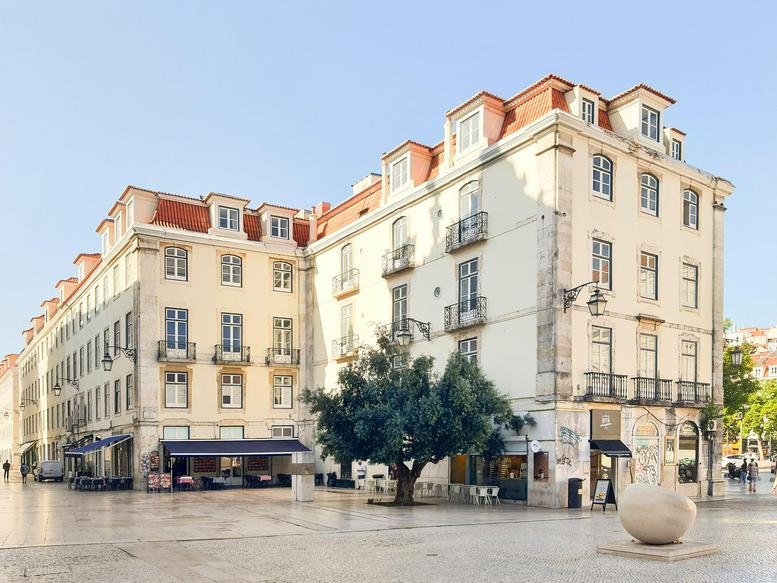 Exterior facade of the classic building at 74 Praça Dom Pedro IV in the heart of Lisbon.