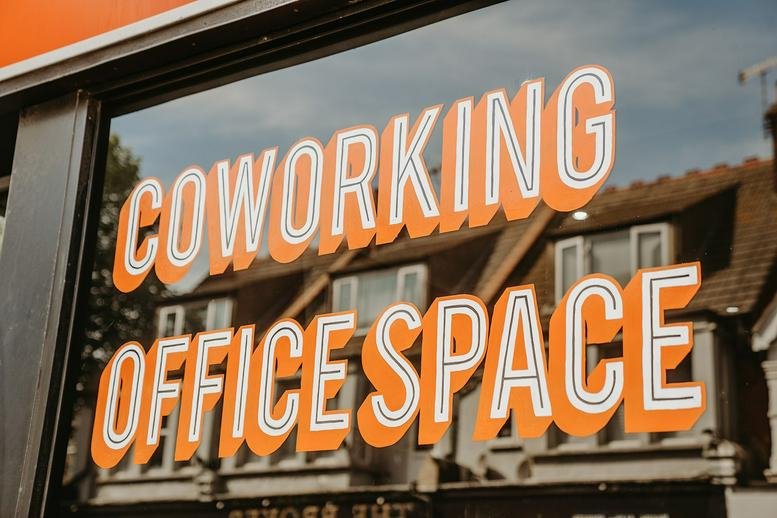 Exterior signage for Office Central, 9a Fairfax Drive, featuring orange typography on a glass window.