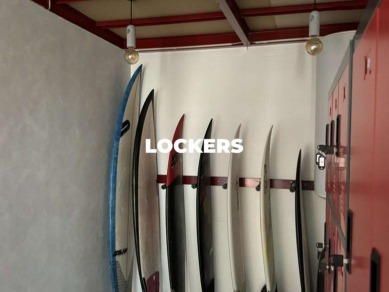 Locker room with surfboard storage and red metal lockers.