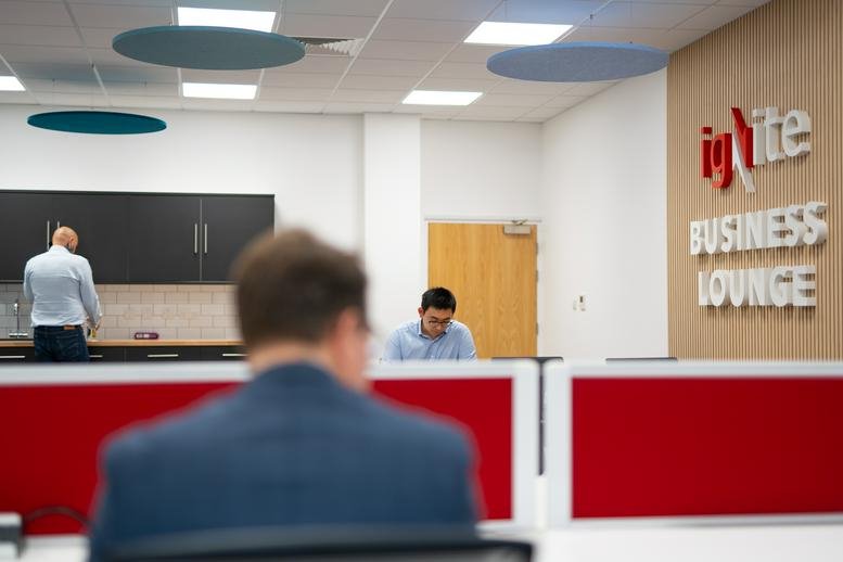 Spacious business lounge at The Venture Centre, Sir William Lyons Road, Coventry with modern workstations.
