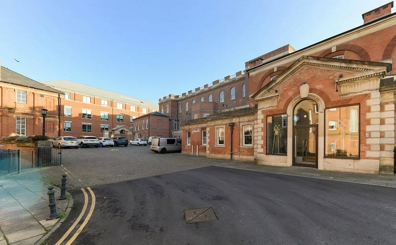 Exterior of the historic red brick facade at Standard Court, Royal Standard Place.