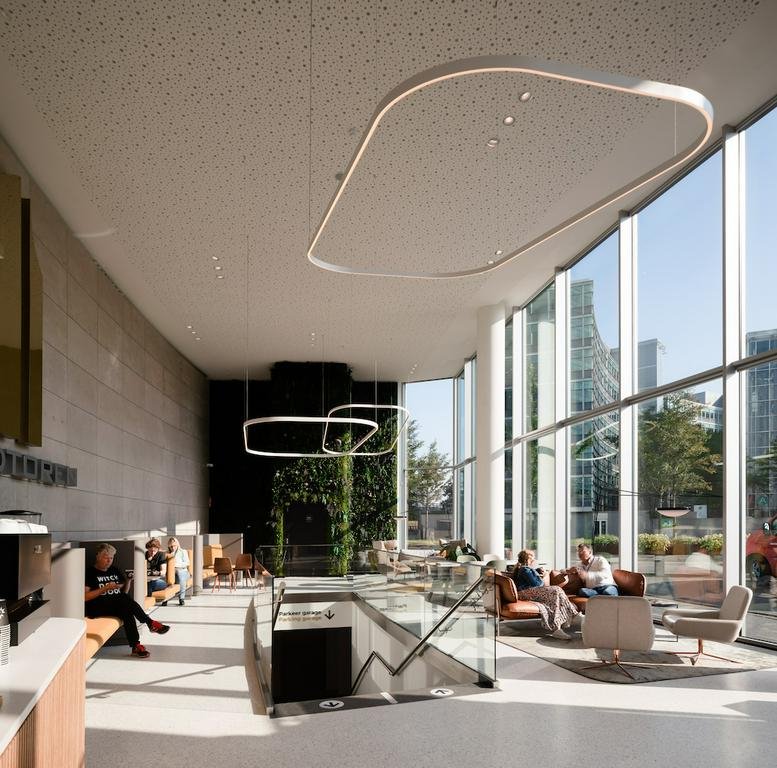 Spacious sunlit lobby at Taurusavenue 3 with high ceilings and sculptural light fixtures.