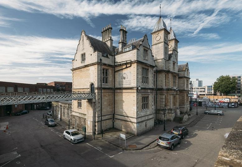 Exterior view of the historic stone facade at Temple 1852 with its distinctive clock towers.
