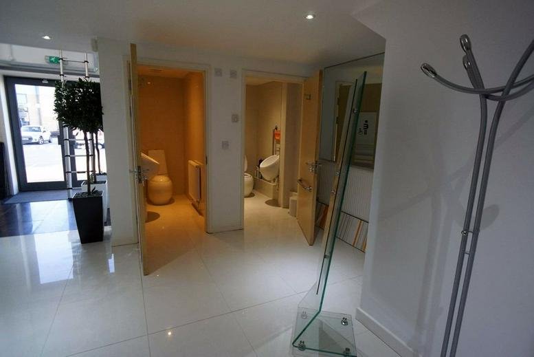 Modern reception area at Unit E3, Trentham Business Quarter with polished white floors and tall indoor plants.