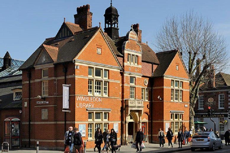 Grand red brick exterior of the Wimbledon Reference Library with classic architectural details.