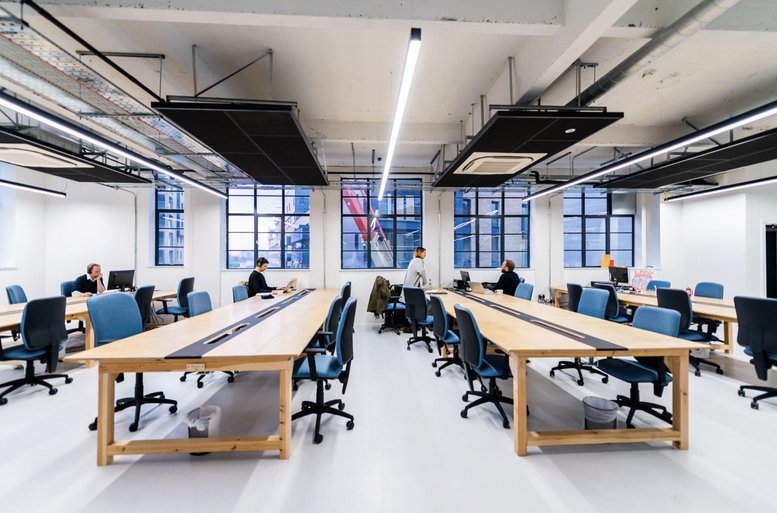 Spacious open-plan workspace at Creative Works, 7 Blackhorse Road with long wooden desks and natural light.