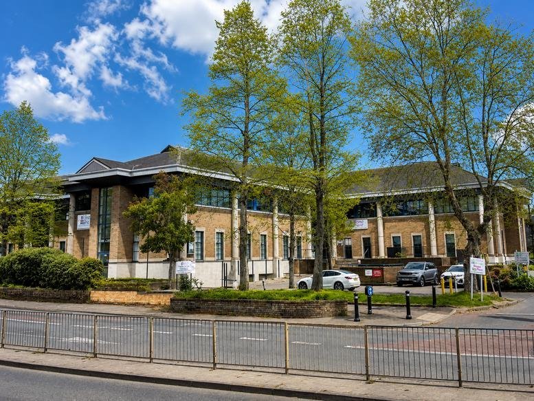 Exterior view of the brick facade and landscaped entrance at Crown House, Home Gardens.