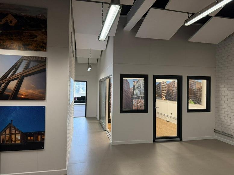 Spacious reception area at Crown Street with framed architectural photography and natural light.