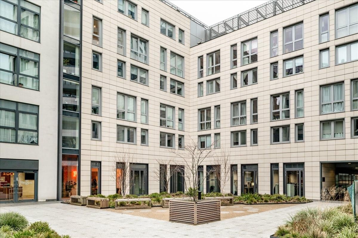 Exterior view of the light-colored stone facade and inner courtyard at Eagle House.