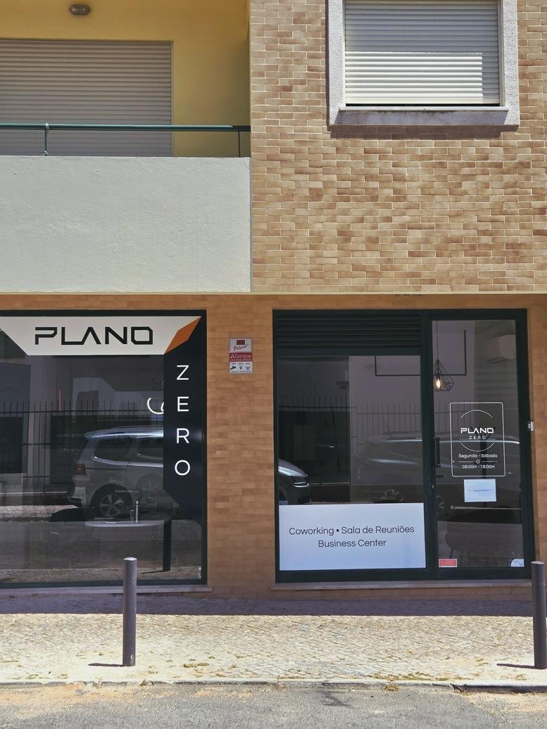 Street view of the modern storefront featuring large glass windows and minimalist signage.