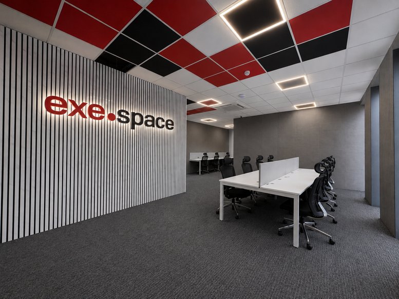 Spacious open-plan workspace at Exeland House, Tudor Street with a red and black checkered ceiling.