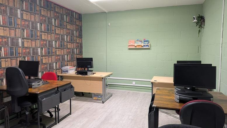 Spacious workspace at Kings Chase Shopping Centre with desks and a bookshelf feature wall.