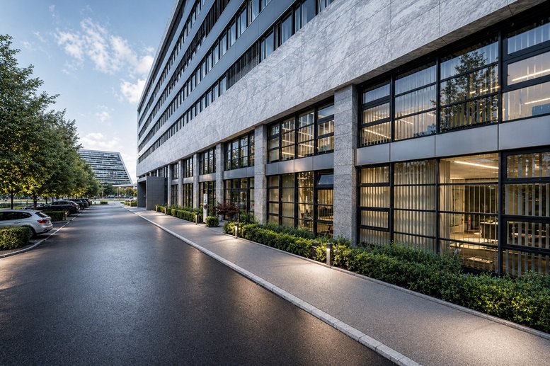 Exterior view of the modern glass and stone facade at Landis + Gyr-Strasse 1.