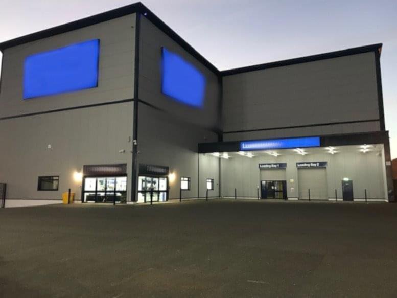 Modern exterior of 1 Portway Road, Wednesbury, WS10 7DZ with large blue panels and paved parking area.