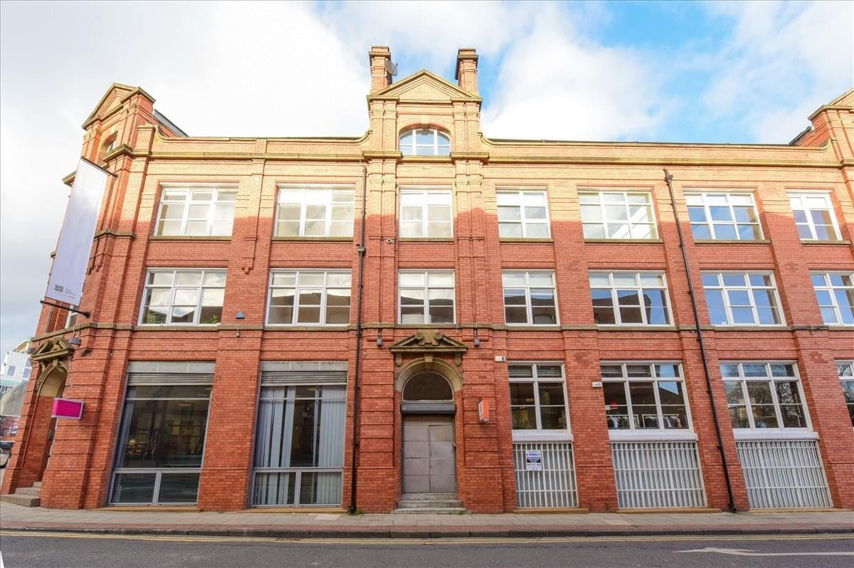 Full exterior view of the historic red brick and sandstone building.
