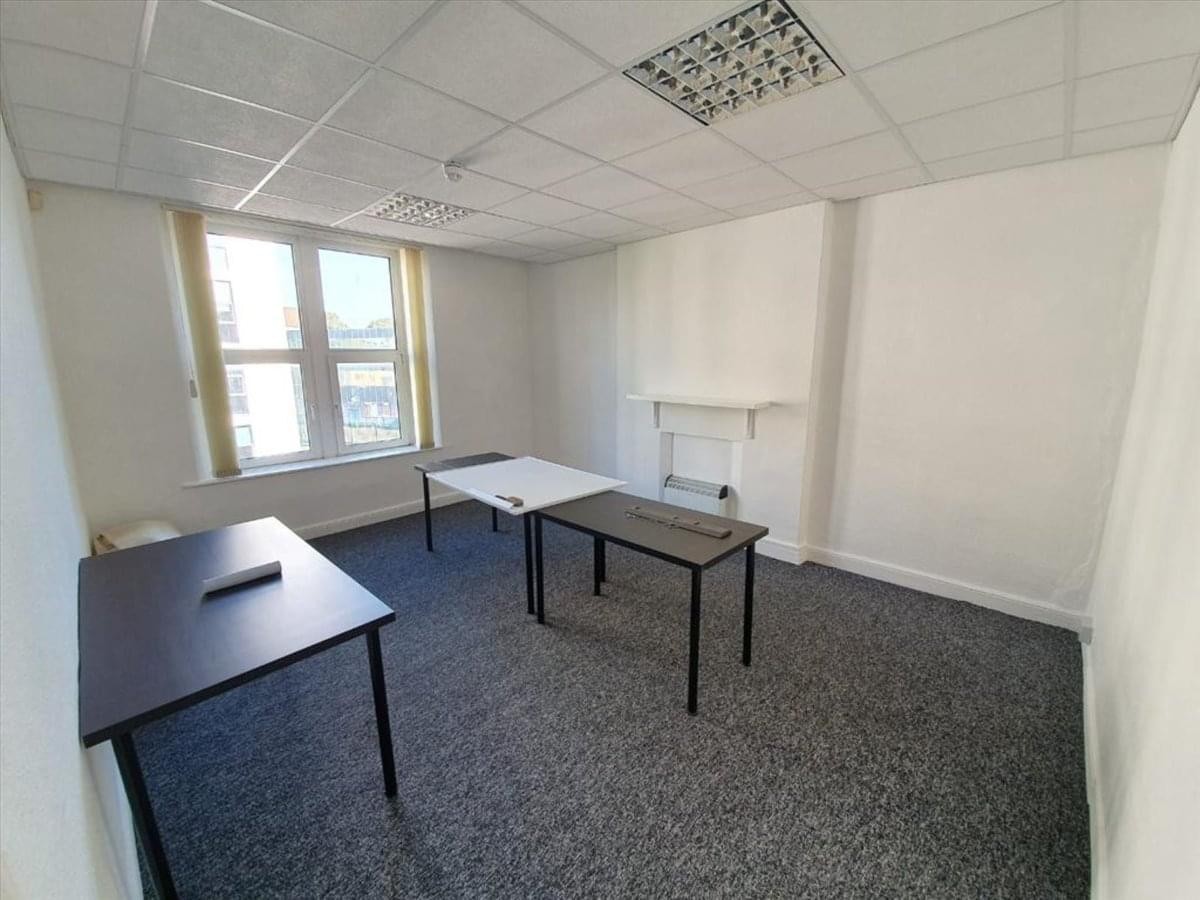 Spacious three-person office suite at 16 Museum Place with bright natural light and grey carpets.