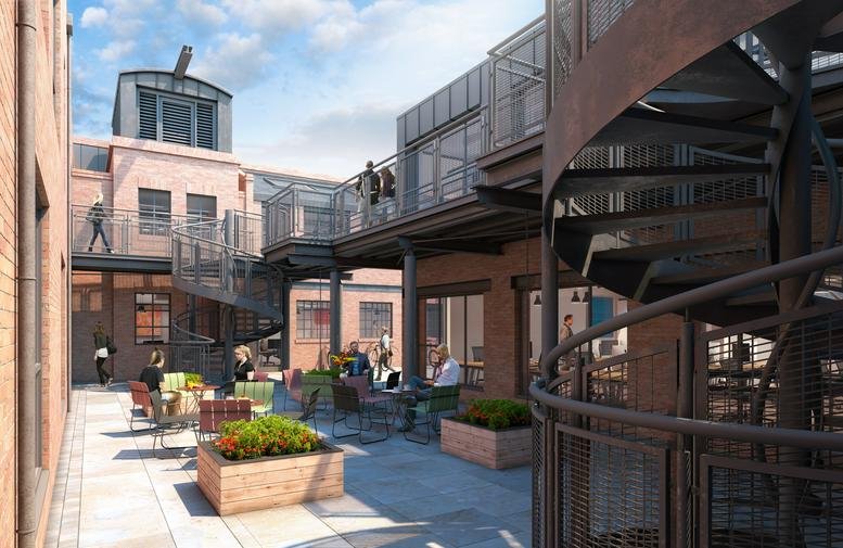 Exterior view of the brick facade and industrial courtyard at Huguenot Place, 17 Heneage Street.