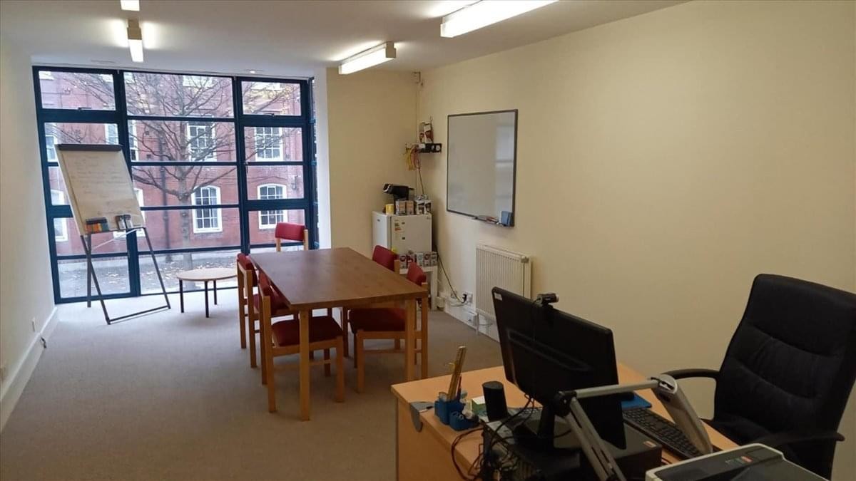 Spacious meeting room at 18 club row with a large wooden table and natural light.