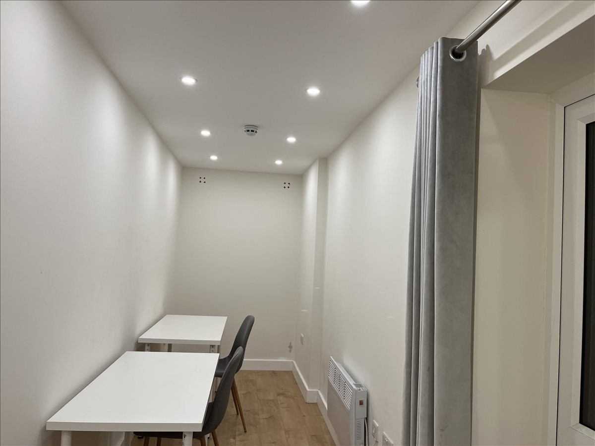 Bright, white private office with two desks and modern recessed lighting at 18 Marylebone High Street.