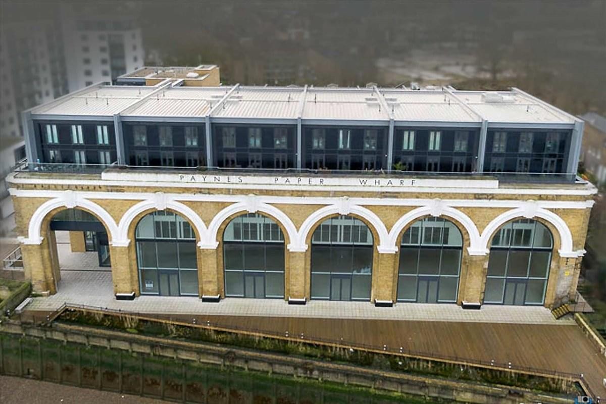 Exterior view of the historic arched facade and modern upper levels at 23 Wharf Street, Greenwich.
