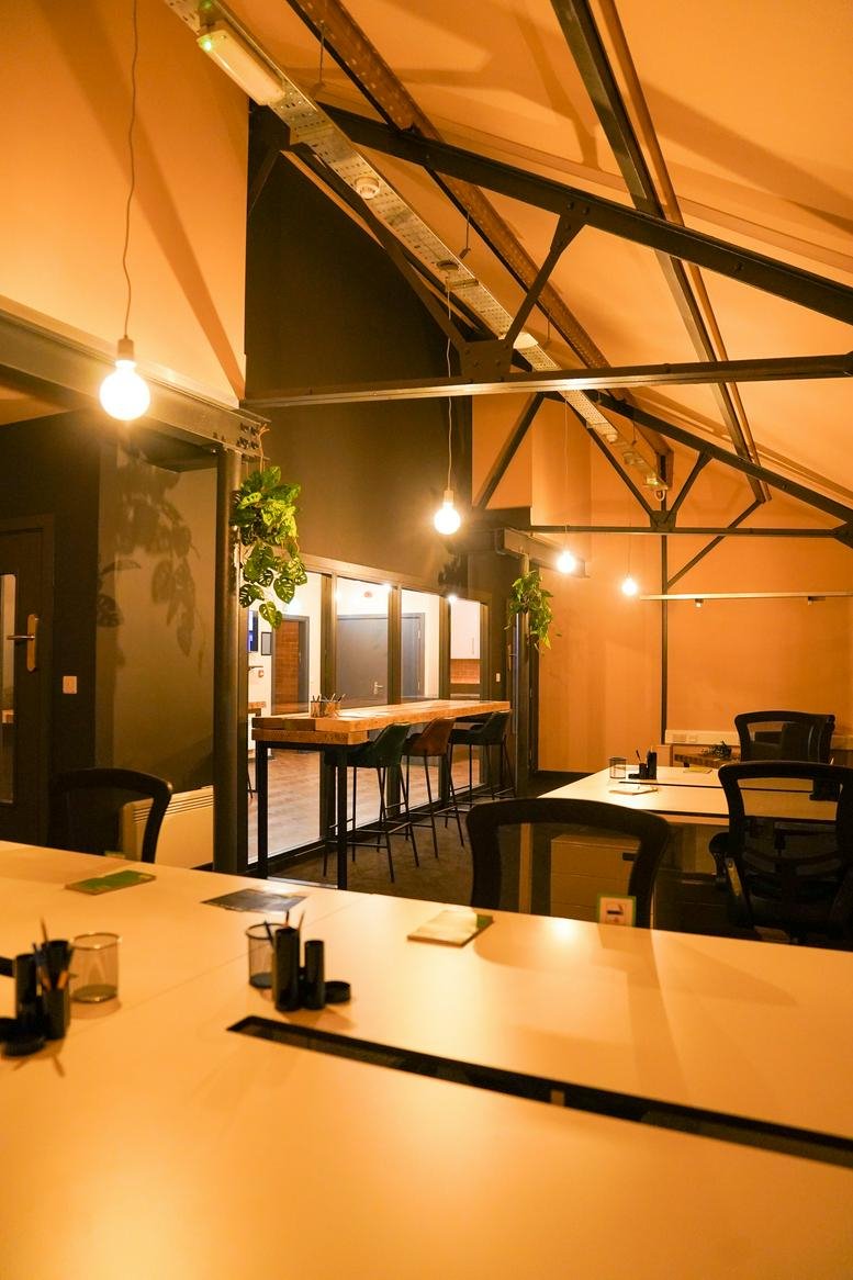 Spacious co-working area at 2nd & 3rd Floor, 30 West Street with exposed beams and hanging lights.